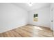 Neutral bedroom features wood floors, a window, and a blank canvas for personalization at 8717 Lawyers Rd, Charlotte, NC 28227
