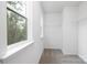 Walk-in closet is carpeted and has wire shelves and windows for organization and natural light at 8717 Lawyers Rd, Charlotte, NC 28227