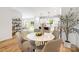 Bright dining area featuring hardwood floors, a stylish table, and open flow to the kitchen at 8717 Lawyers Rd, Charlotte, NC 28227