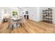 Cozy dining area with modern table, hardwood floors, and views into the living room at 8717 Lawyers Rd, Charlotte, NC 28227