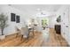 Stylish dining area with hardwood flooring, a modern table, and seamless flow to living areas at 8717 Lawyers Rd, Charlotte, NC 28227