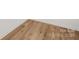 Close-up of the wood-look flooring with subtle textures and a clean baseboard at 8717 Lawyers Rd, Charlotte, NC 28227