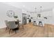 Eat-in kitchen with stainless steel appliances, granite countertops, a breakfast bar and seamless access to dining and living areas at 8717 Lawyers Rd, Charlotte, NC 28227