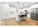 Contemporary kitchen with white cabinets, stainless steel appliances, and convenient island seating at 8717 Lawyers Rd, Charlotte, NC 28227