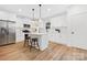 Bright, modern kitchen featuring white cabinetry, stainless steel appliances, and a center island at 8717 Lawyers Rd, Charlotte, NC 28227