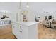 Open-concept kitchen with white island, stainless appliances, and seamless access to dining and living areas at 8717 Lawyers Rd, Charlotte, NC 28227