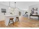 Modern, bright kitchen showcases a center island with bar seating and seamlessly integrates into the dining and living spaces at 8717 Lawyers Rd, Charlotte, NC 28227