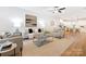 Bright, open-concept living room featuring neutral decor, modern furniture, and hardwood floors at 8717 Lawyers Rd, Charlotte, NC 28227