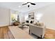 Bright living room featuring large windows, neutral decor, comfortable furniture, and hardwood floors at 8717 Lawyers Rd, Charlotte, NC 28227