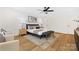 Spacious main bedroom features a ceiling fan, large windows, and neutral colors at 8717 Lawyers Rd, Charlotte, NC 28227