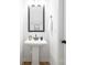 Powder room features a pedestal sink, black faucet and mirror and white trim at 8717 Lawyers Rd, Charlotte, NC 28227