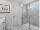 Bright bathroom featuring a glass-enclosed shower with gray tile and a white vanity at 1005 Cheviot Ct, Waxhaw, NC 28173