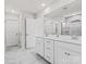 Bathroom with double vanity, large mirror, tile floor, and glass-enclosed shower providing a spa-like experience at 1005 Cheviot Ct, Waxhaw, NC 28173