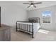Bedroom with a metal frame bed, ceiling fan, and natural light from the window at 1005 Cheviot Ct, Waxhaw, NC 28173