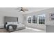 Bright primary bedroom featuring neutral walls, carpet, ceiling fan and three windows providing plenty of natural light at 1005 Cheviot Ct, Waxhaw, NC 28173