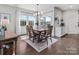Open dining area with large windows and hardwood floors, flowing into the kitchen at 1005 Cheviot Ct, Waxhaw, NC 28173