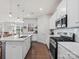 Bright kitchen with white cabinets, stainless steel appliances, and hardwood floors at 1005 Cheviot Ct, Waxhaw, NC 28173