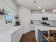 Bright kitchen boasts white cabinetry, quartz countertops, stainless steel appliances, and pendant lighting at 1005 Cheviot Ct, Waxhaw, NC 28173