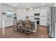 Bright kitchen with white cabinets, stainless steel appliances, and island with seating at 1005 Cheviot Ct, Waxhaw, NC 28173