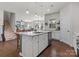Kitchen features large island, white cabinets, stainless steel appliances, and seating at 1005 Cheviot Ct, Waxhaw, NC 28173