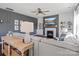 Living room features a fireplace, built-in shelving, a ceiling fan and hardwood floors at 1005 Cheviot Ct, Waxhaw, NC 28173