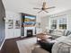 Living room with fireplace, built-in shelving, hardwood floors, and comfortable seating at 1005 Cheviot Ct, Waxhaw, NC 28173