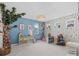 Playroom with tree-like bookshelf, colorful storage and decor at 1005 Cheviot Ct, Waxhaw, NC 28173