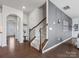 Hallway with staircase features hardwood floors and decorative wall paneling at 1005 Cheviot Ct, Waxhaw, NC 28173