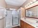 Bathroom with a glass-enclosed shower, and double sink vanity with wood cabinets at 10727 Ryan Courtney Sq, Mint Hill, NC 28227