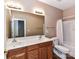 Bathroom featuring a double vanity, framed mirror, and a shower-tub combination with white tiling at 10727 Ryan Courtney Sq, Mint Hill, NC 28227