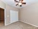 Bedroom with a ceiling fan, neutral paint, and double-door closet provides comfortable living space at 10727 Ryan Courtney Sq, Mint Hill, NC 28227