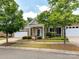 Attractive brick home showcasing well-kept landscaping and a covered entryway with supporting columns at 10727 Ryan Courtney Sq, Mint Hill, NC 28227
