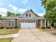 Lovely brick home featuring a two-car garage and well-maintained landscaping on a sunny day at 10727 Ryan Courtney Sq, Mint Hill, NC 28227
