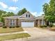 Lovely brick home featuring a two-car garage and well-maintained landscaping on a sunny day at 10727 Ryan Courtney Sq, Mint Hill, NC 28227
