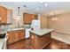 Kitchen with wood cabinets, island, and granite counters connects to the dining area at 10727 Ryan Courtney Sq, Mint Hill, NC 28227