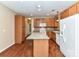 Bright kitchen features wood cabinets, white appliances, and an island with granite countertops at 10727 Ryan Courtney Sq, Mint Hill, NC 28227