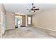 Expansive living area features neutral carpet, ceiling fan, and entry view at 10727 Ryan Courtney Sq, Mint Hill, NC 28227