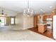 Open-concept living space shows a dining area, chandelier, and kitchen at 10727 Ryan Courtney Sq, Mint Hill, NC 28227