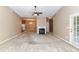 Spacious living area with carpet, fireplace, and open access to adjacent rooms for flexible living at 10727 Ryan Courtney Sq, Mint Hill, NC 28227