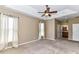 Bright main bedroom featuring a tray ceiling, ceiling fan, carpet, and two windows at 10727 Ryan Courtney Sq, Mint Hill, NC 28227