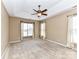 Spacious main bedroom with a tray ceiling, a ceiling fan, and large windows at 10727 Ryan Courtney Sq, Mint Hill, NC 28227