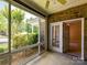 Screened-in patio with brick walls, ceiling fan, and view of the landscaped backyard at 10727 Ryan Courtney Sq, Mint Hill, NC 28227