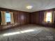 Bedroom showing wood paneling, neutral-toned carpet and natural light from two windows at 1074 25Th Ne St, Hickory, NC 28601