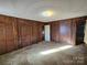 Bedroom featuring neutral-toned carpet, wood paneling, and closet doors at 1074 25Th Ne St, Hickory, NC 28601