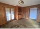 Bedroom showcasing wood paneling, built-in shelving, and neutral-toned carpet at 1074 25Th Ne St, Hickory, NC 28601