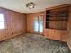 Bedroom showcasing wood paneling, built-in shelving and neutral-toned carpet at 1074 25Th Ne St, Hickory, NC 28601