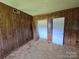 Bedroom featuring paneled walls, carpet, and two entry doors at 1074 25Th Ne St, Hickory, NC 28601