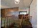 Entryway with wooden railings and wood paneled wall, and view into other rooms at 1074 25Th Ne St, Hickory, NC 28601