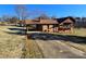 View of brick home featuring a covered carport, second story balcony, and long driveway at 1074 25Th Ne St, Hickory, NC 28601