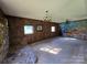 Living room with paneled walls, stone fireplace and mountain mural at 1074 25Th Ne St, Hickory, NC 28601